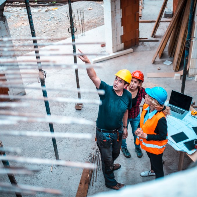 three workers in hardhats at job site